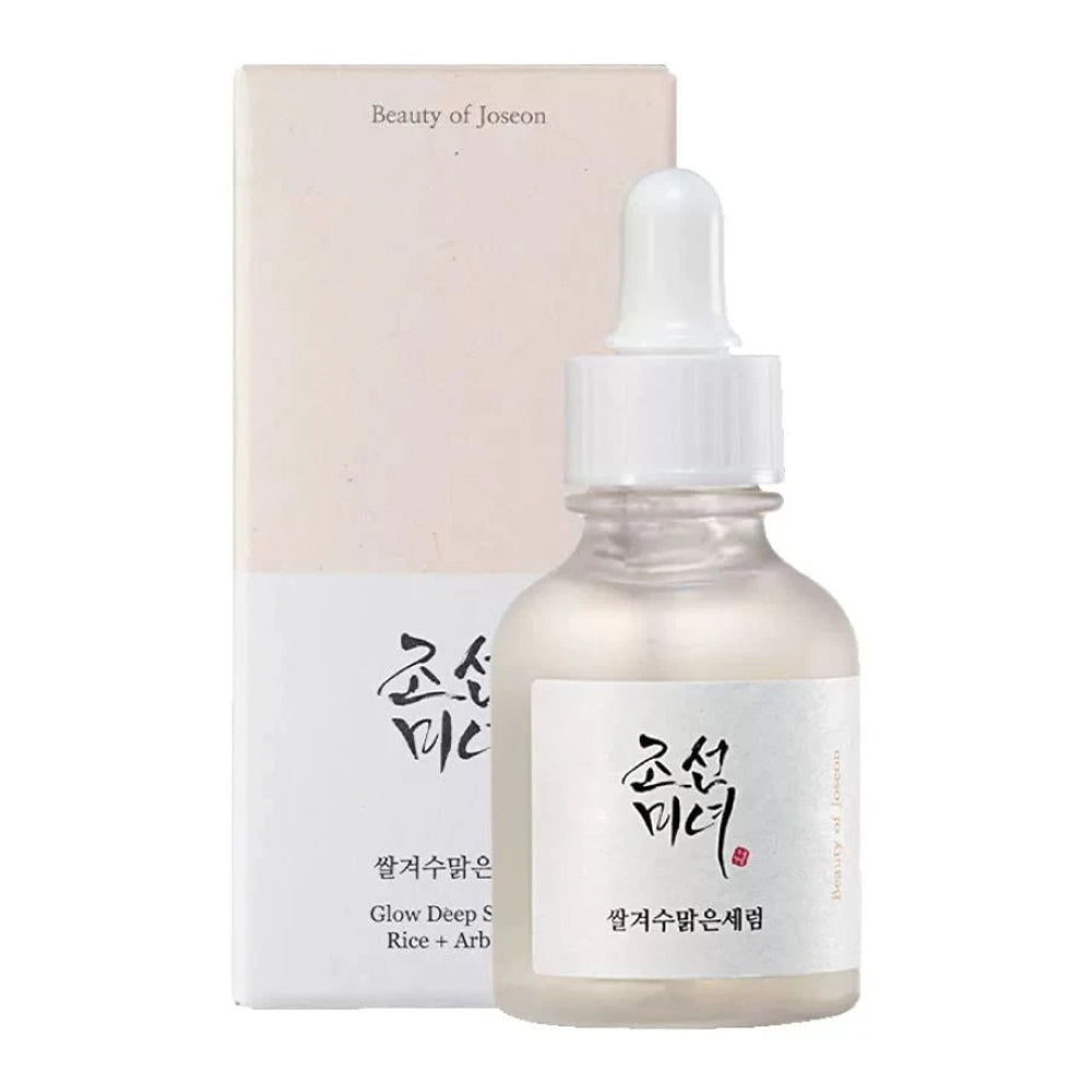 Skincare serum bottle with dropper and packaging on a white background