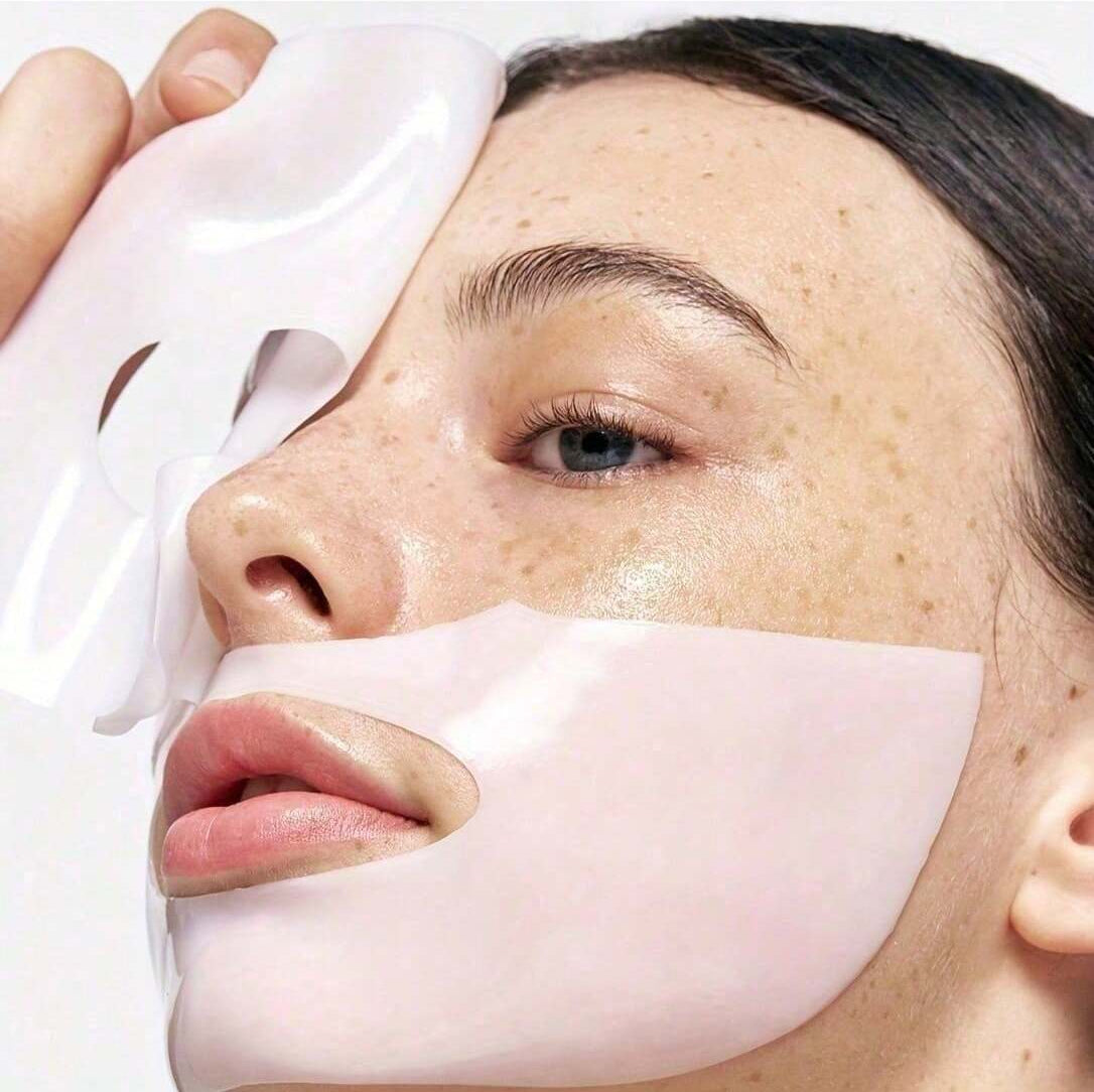 Woman applying a face mask with a focus on her face