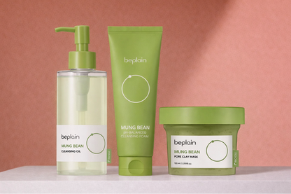 Three green beplan mung bean skincare products from the brand 'beplain' on a pink background