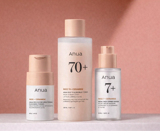 Three Anua skincare products on a pink background