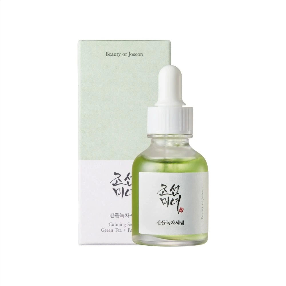 Skincare serum bottle with dropper and packaging on a white background